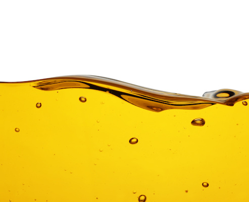 Cooking oil flow isolated on white. Color liquid